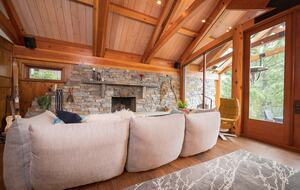 Down filled couch for apres ski lounging, with rock fireplace