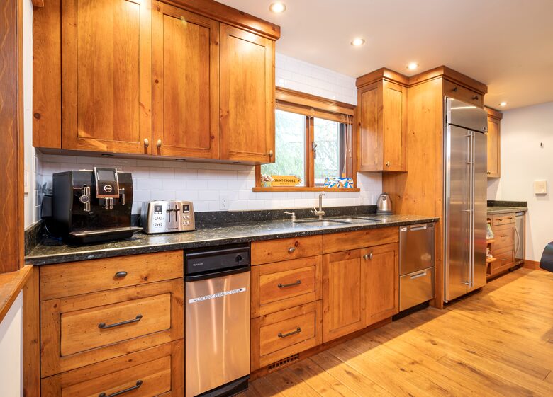 Lots of kitchen counter space with espresso machine and wine fridge
