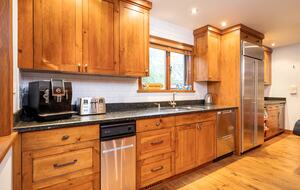 Lots of kitchen counter space with espresso machine and wine fridge