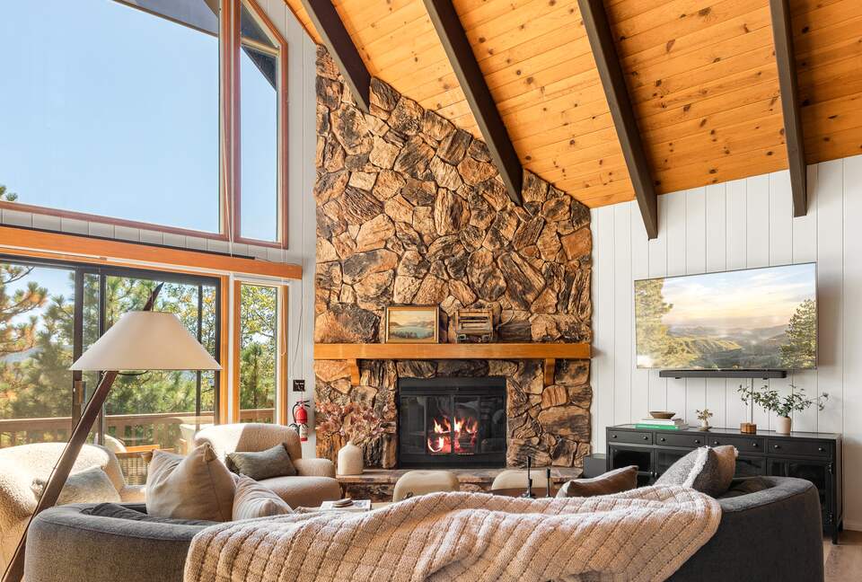 Vaulted ceilings, fireplace, and mountain views