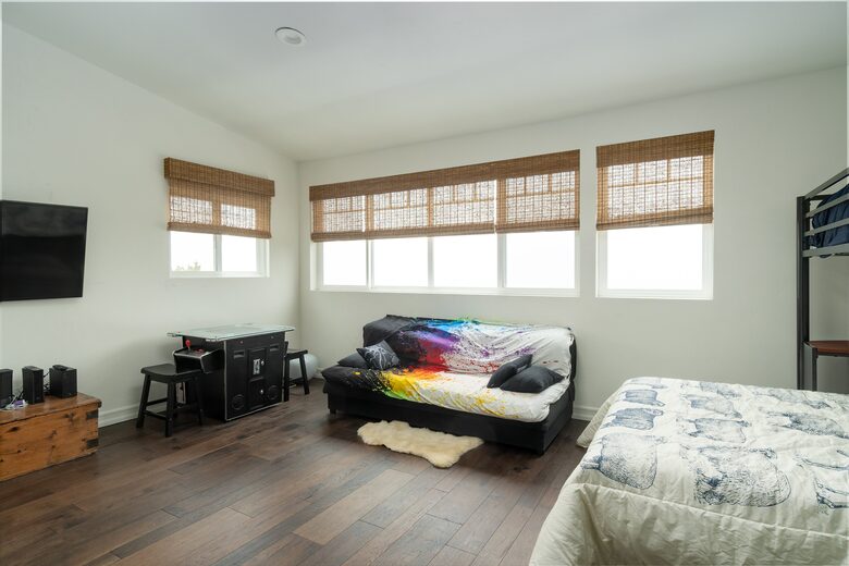 Second floor kids' bedroom with video game table and TV.