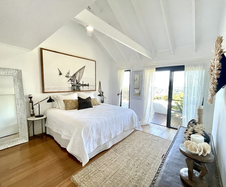 Master bedroom with King bed and outdoor bath and ensuite bathroom