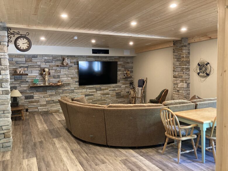 large recreation room with 70' tv and large sectional