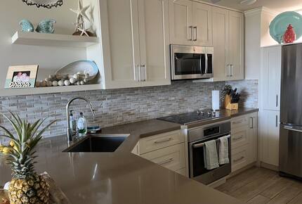 Sunny kitchen with dishwasher, built in range and oven.