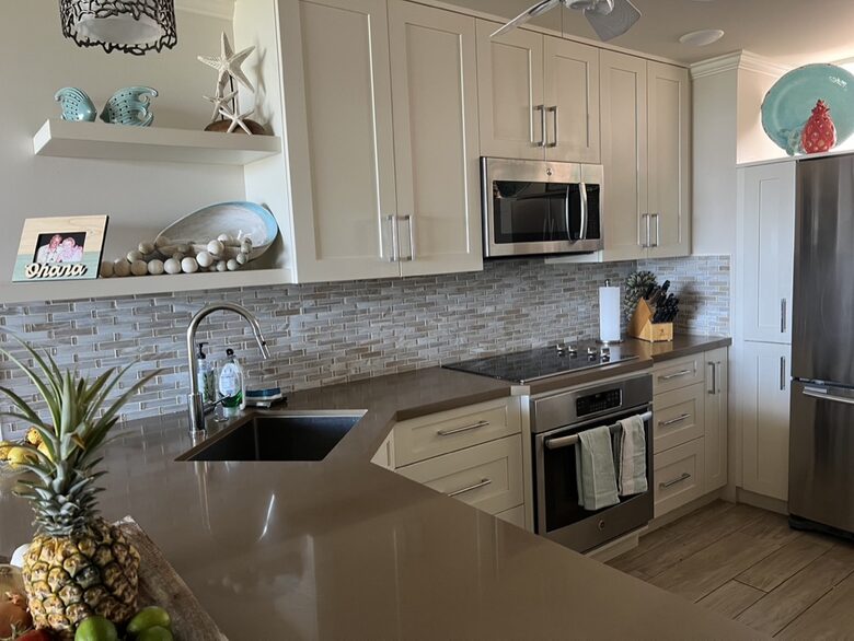 Sunny kitchen with dishwasher, built in range and oven.