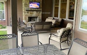 Outdoor Living area with fireplace and outdoor TV