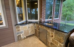 Outdoor kitchen with sink, gas grill and side burner