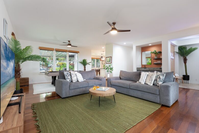 Open living room with wet bar in the back