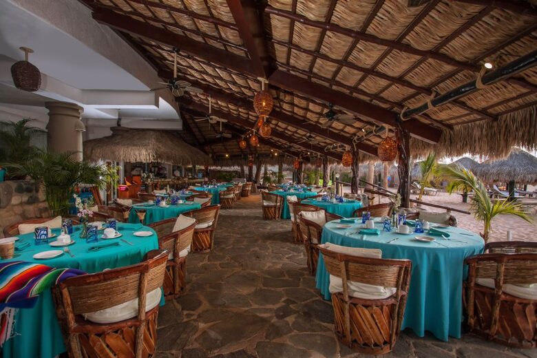 Cascadas Grill under palapa dining or on the beach