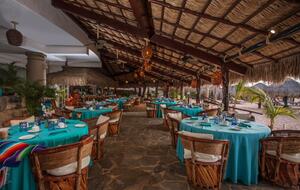 Cascadas Grill under palapa dining or on the beach