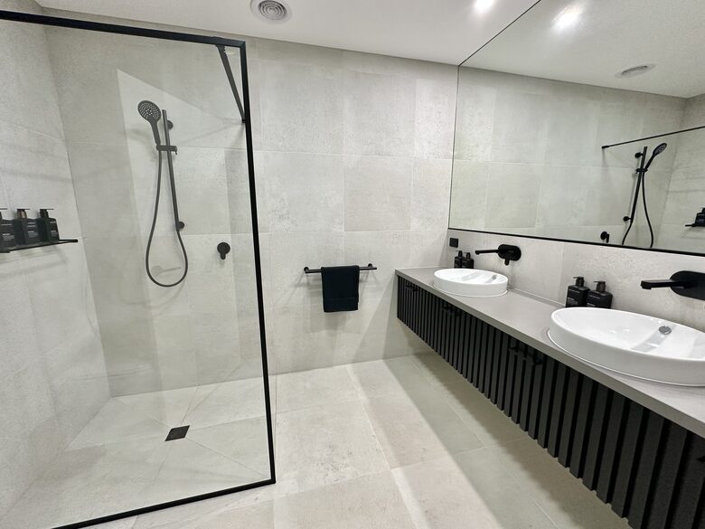 2nd of 4 bathrooms with batten dual basin vanity
