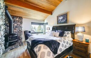 Upper Master w/ wood burning fireplace & partial Lake views