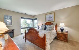 Lower master w/electric fireplace & partial lake views