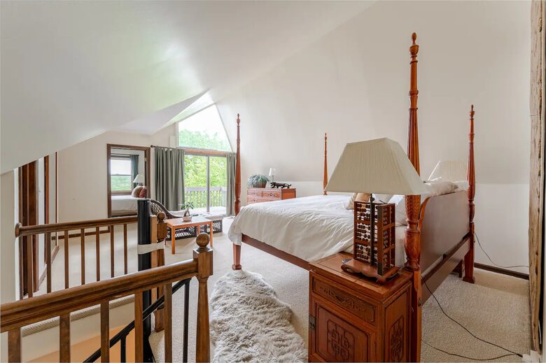 Primary Bedroom with private deck facing river and pool