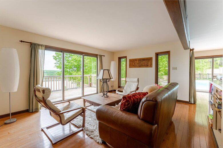 Less formal living room, open kitchen and pool to the right