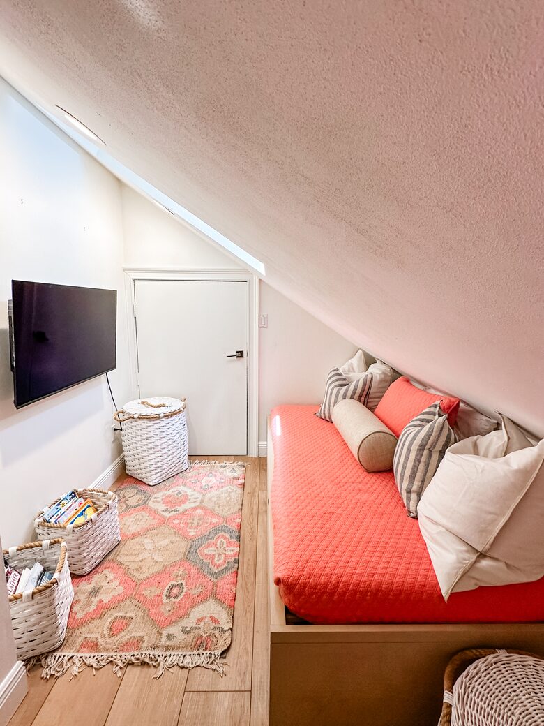 Upstairs kids game nook with twin daybeds and Xbox gaming system.