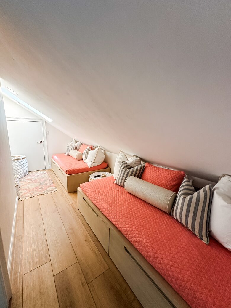 Upstairs kids game nook with twin daybeds and Xbox gaming system.