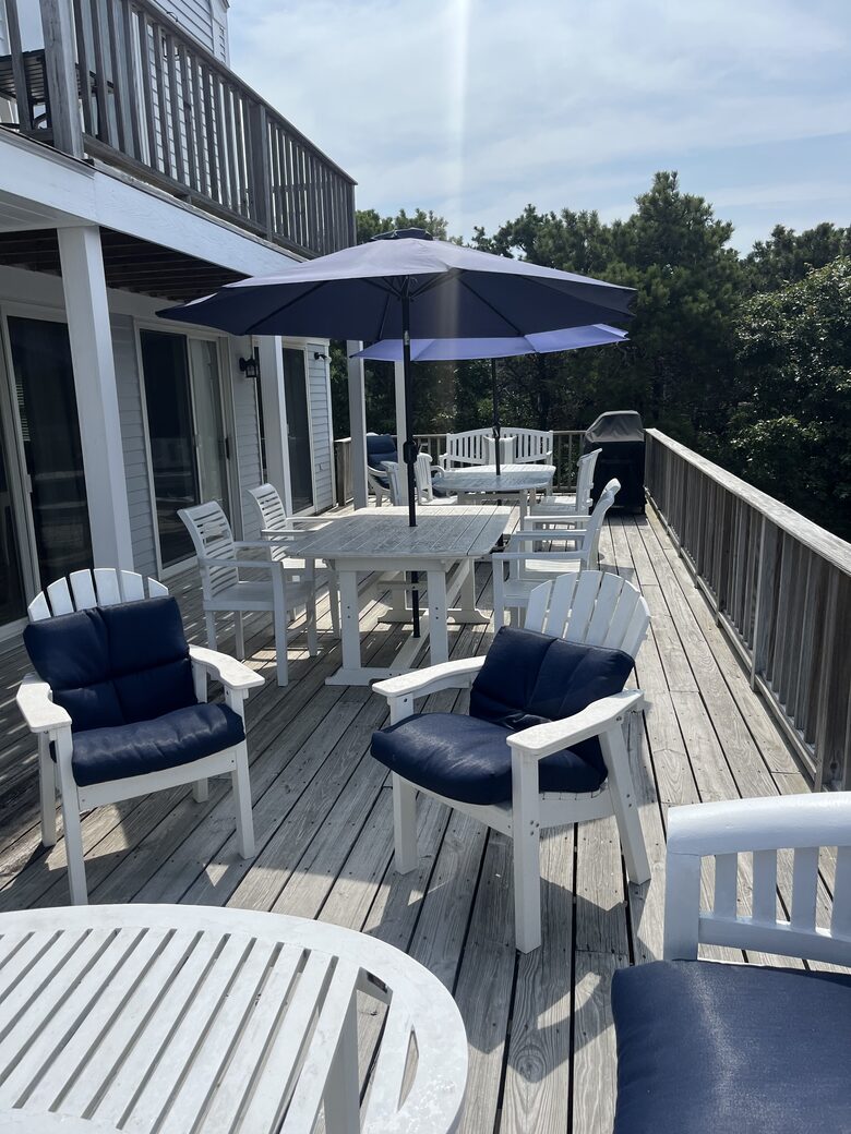 Second floor deck with grill and dining and seating