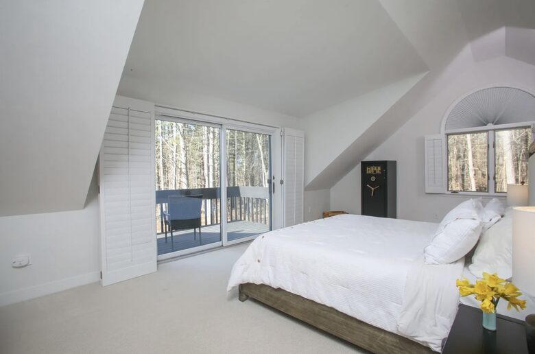 Upstairs primary suite has deck overlooking back w/ walk-in closets