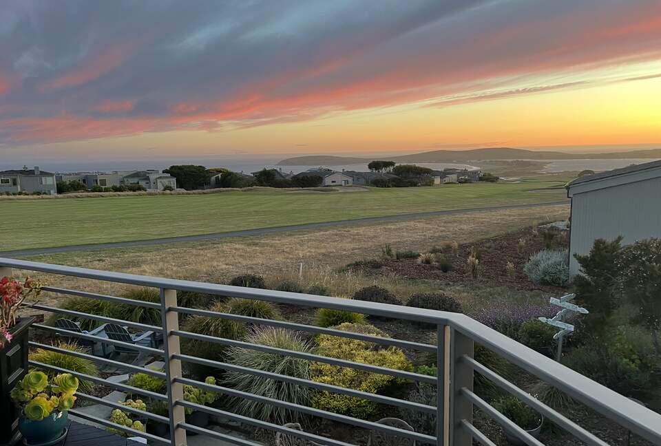 Summer sunset from primary bedroom balcony.