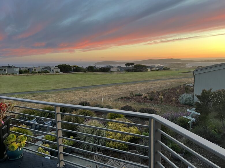Summer sunset from primary bedroom balcony.