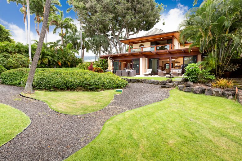 View of the backyard/downstairs and upstairs lanai