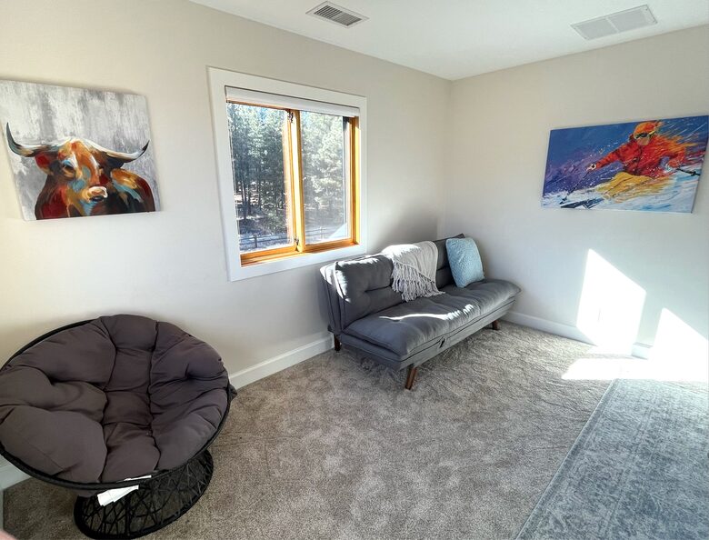 Upstairs loft area with futon and chair