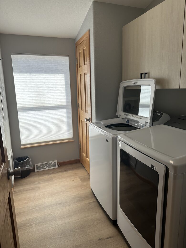 Laundry room with new washer and dryer