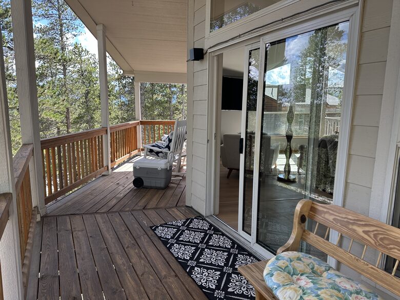 balcony off the dining room with forest views