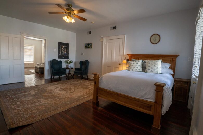 This spacious bedroom features a comfortable wooden bed