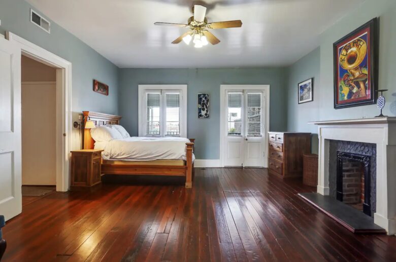 This spacious bedroom features a comfortable wooden bed