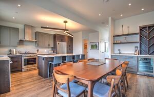 The kitchen table has seating for 8 plus a large island