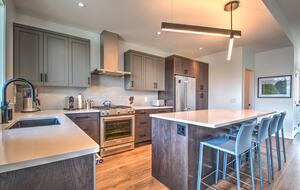 The modern kitchen is fully stocked with amenities