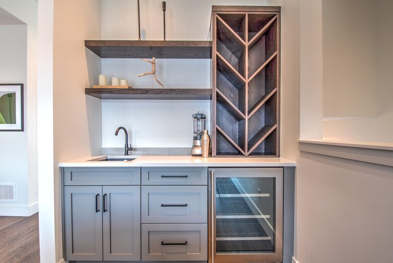 The wet bar includes wine storage and beverage fridge
