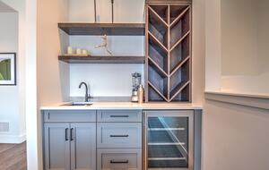 The wet bar includes wine storage and beverage fridge