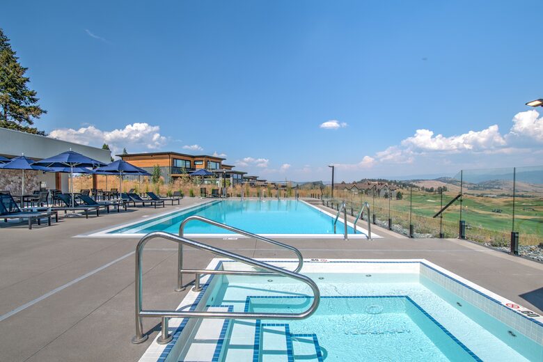 Pool area features jacuzzi and golf course views