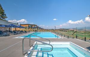 Pool area features jacuzzi and golf course views
