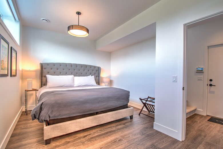 Sunny lower-level bedroom with king bed.