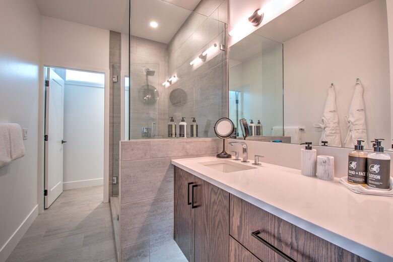 Master bathroom features heated flooring, large glass shower