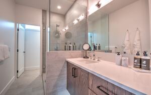 Master bathroom features heated flooring, large glass shower