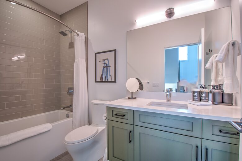 Shared secondary bath features a soaking tub.