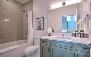 Shared secondary bath features a soaking tub.