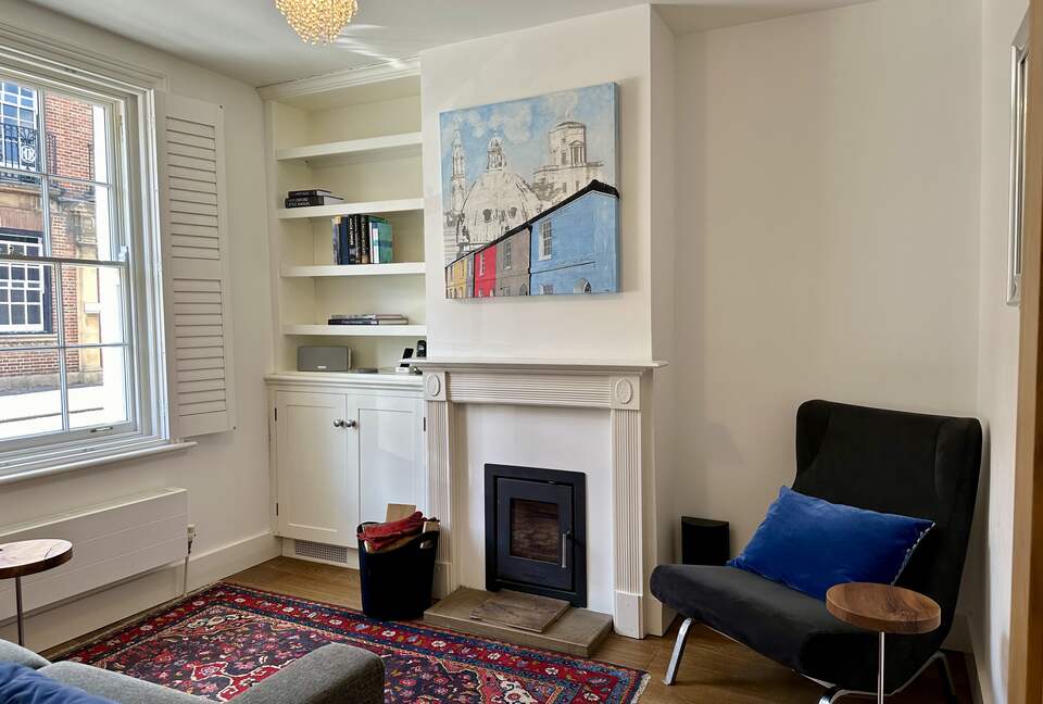 Second sitting room with original artwork and fireplace