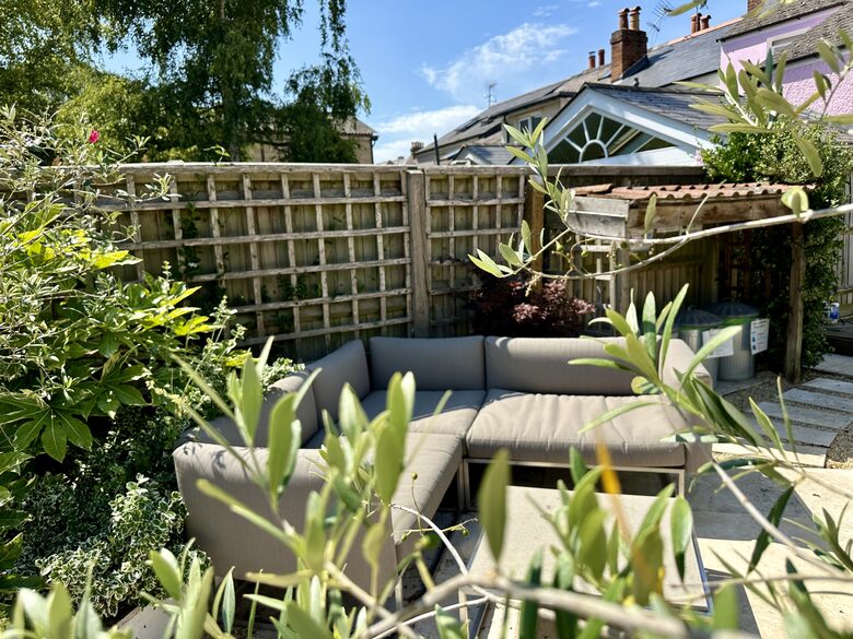 Garden with outdoor sofa and lots of planting