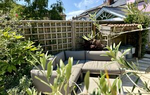 Garden with outdoor sofa and lots of planting