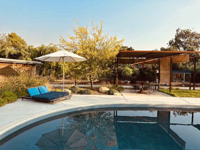 Shaded dining and lounge areas around pool