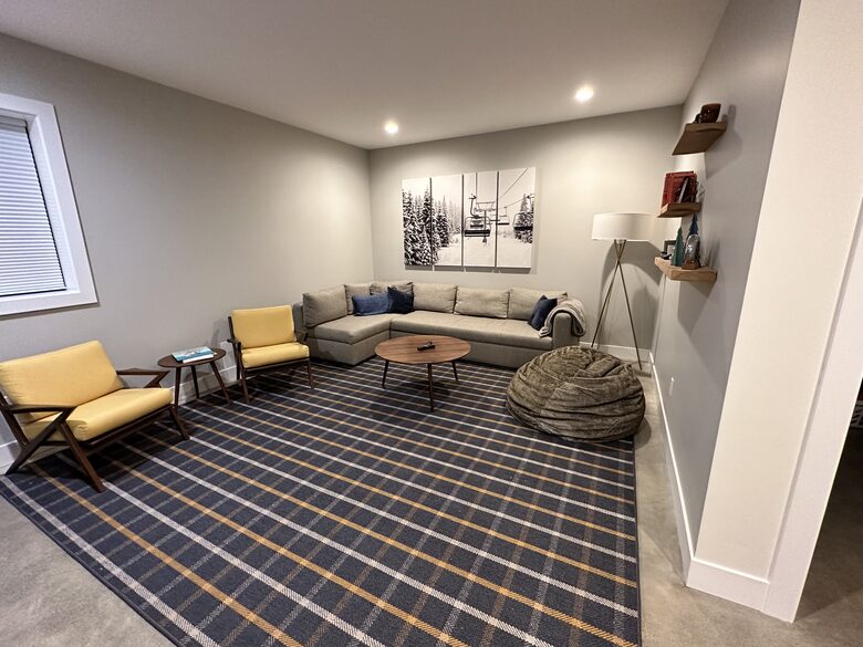 Downstairs home theater space with 72 inch TV