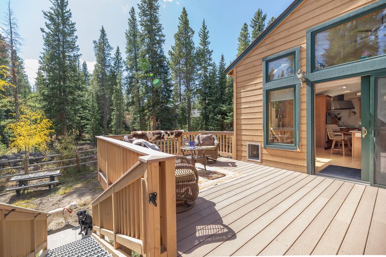 Back Deck stairway leading into fenced in yard