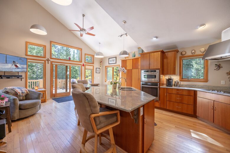 Kitchen out look heavily wooded forrest