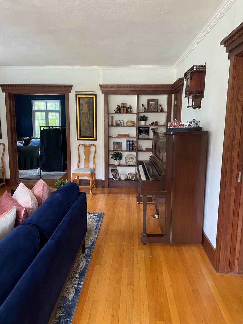 Living room closely connected to den, dining room and porch